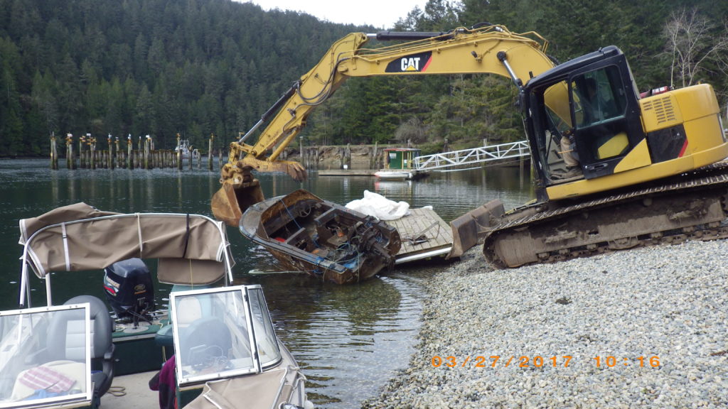 Derelict runabout on work float - SeaChange Marine Conservation Society